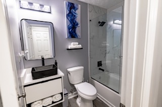 Renovated bathroom with vanity and glass shower enclosure