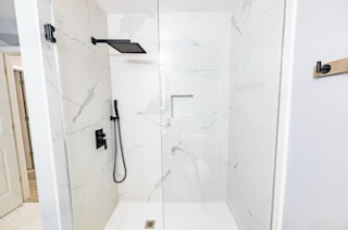 Modern walk-in shower with black fixtures